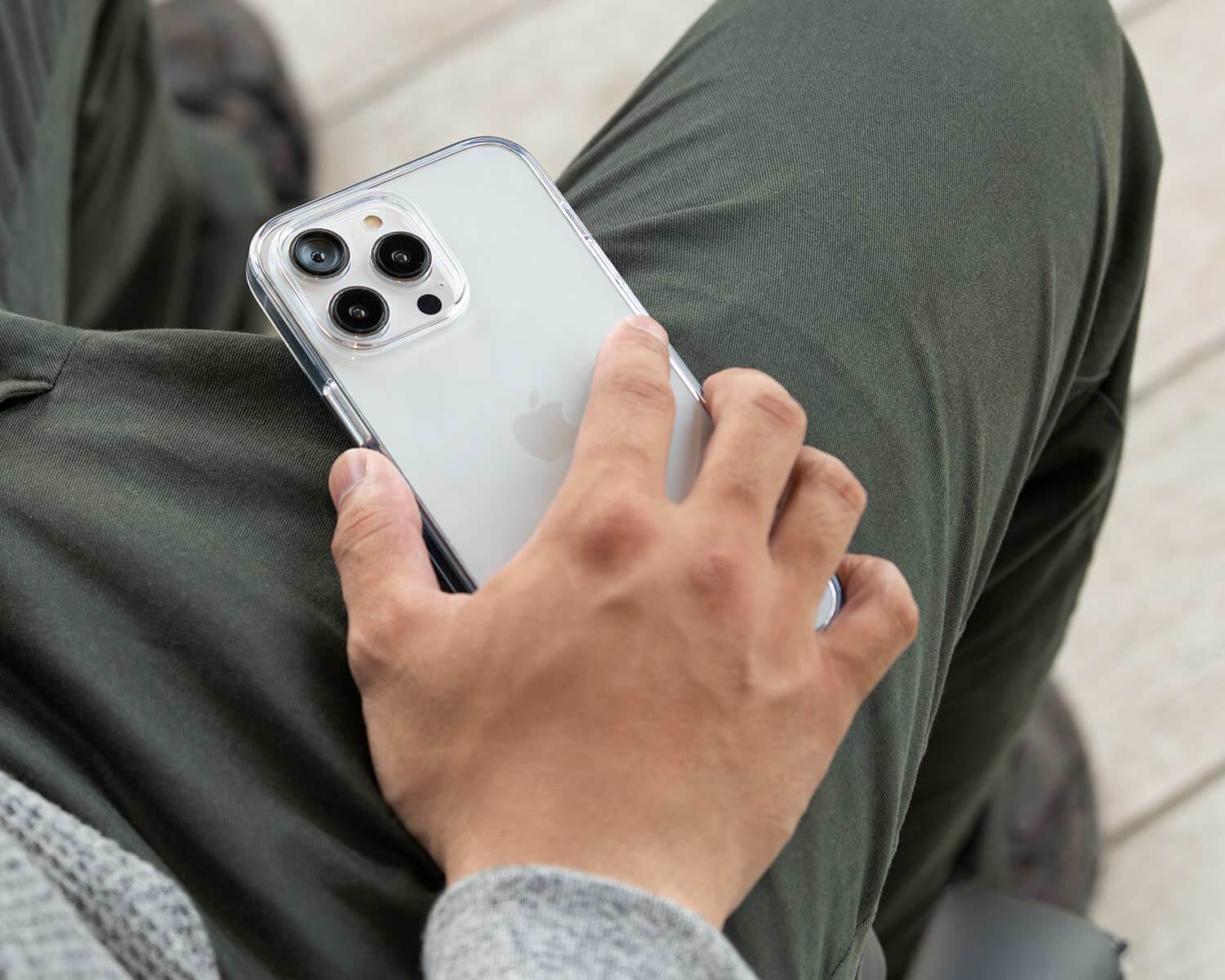 a man holding a clear iPhone 15 pro max case