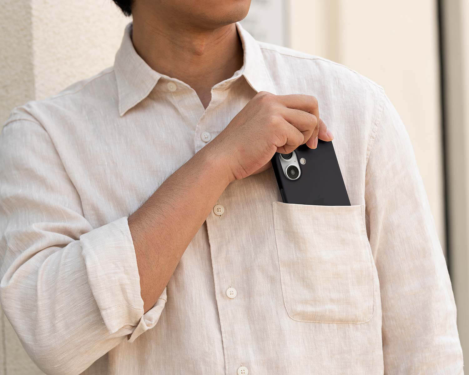a man pocketing an iPhone 16 with a thin case