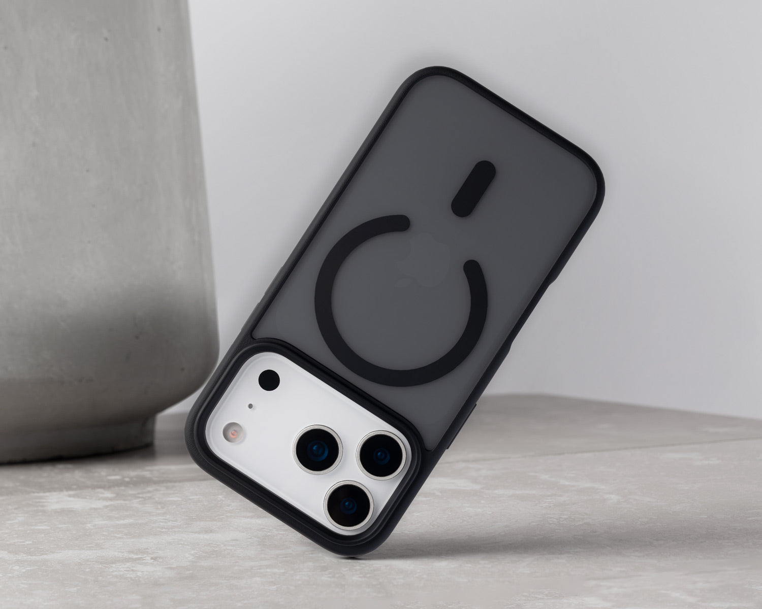 A dark gray MagSafe-compatible iphone 18 pro case with a black bumper frame, shown on a silver smartphone. 