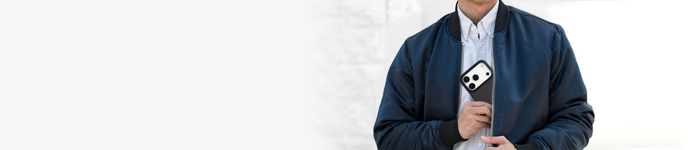 man pulling out a thin phone case out of his jacket