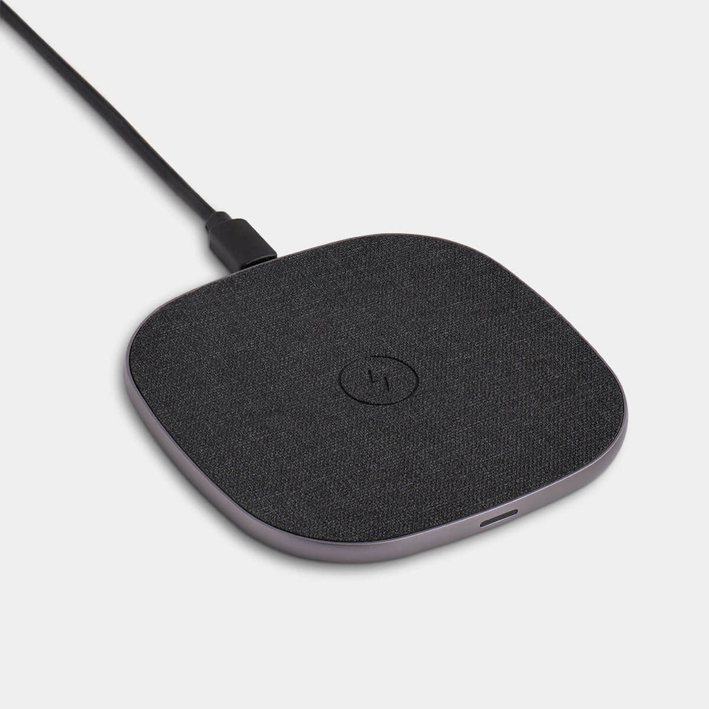 Wireless charger by totallee designed for iPhone, Pixel, and Galaxy. The wireless charger features a fabric top and USB charger